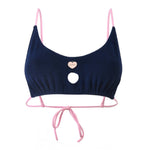 Photo détourée sur fond blanc du haut de maillot de bain Lucia bleu marine et aux bretelles rose blush, en matière éponge