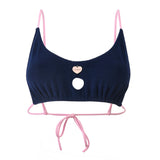 Photo détourée sur fond blanc du haut de maillot de bain Lucia bleu marine et aux bretelles rose blush, en matière éponge
