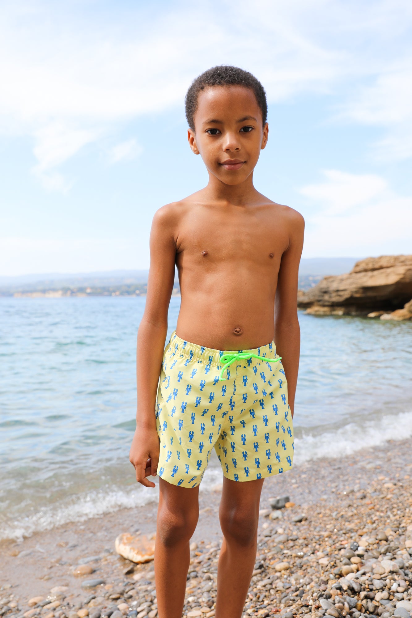 Photo d'un enfant à la plage portant le short de maillot de bain Jano Brai x Poolday