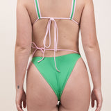 Photo de dos d'une femme portant le haut de maillot de bain Bianca en couleur vert matcha et rose blush