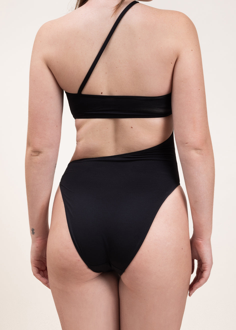 Photo d'une femme de dos portant le maillot de bain une pièce Capri noir