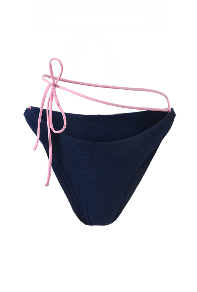 Photo détourée sur fond blanc du bas de maillot de bain Tiana en matière éponge bleu marine à bretelles rose claire